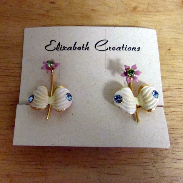 1950s Elizabeth Creations cream enamel floral clip-on earrings with blue rhinestones