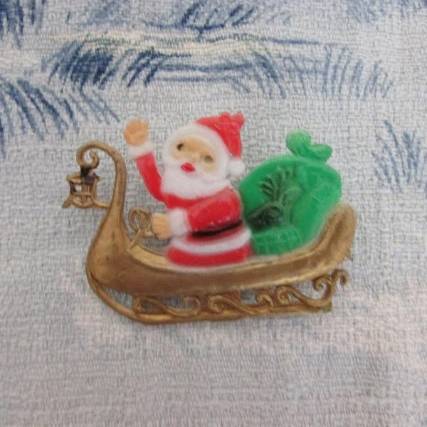 Kitsch home-made brooch using vintage plastic Santa in sleigh cake topper