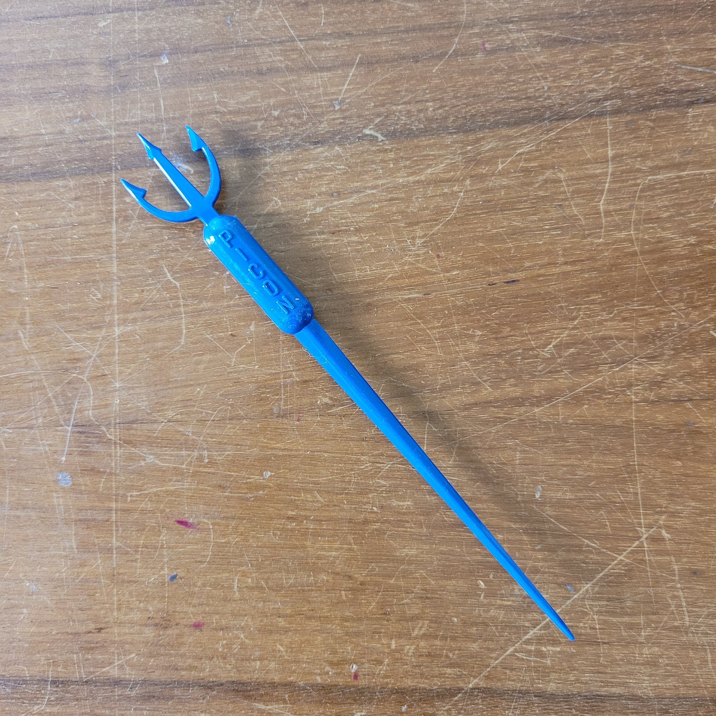 Vintage plastic trident cocktail stirrer, stamped PICON