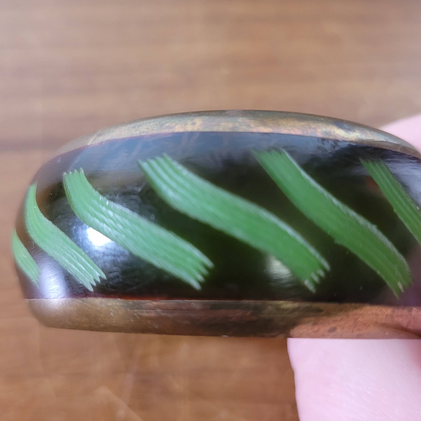 circa. 1980s postmodern black lacquered bangle with green brushstroke motif and brass trim
