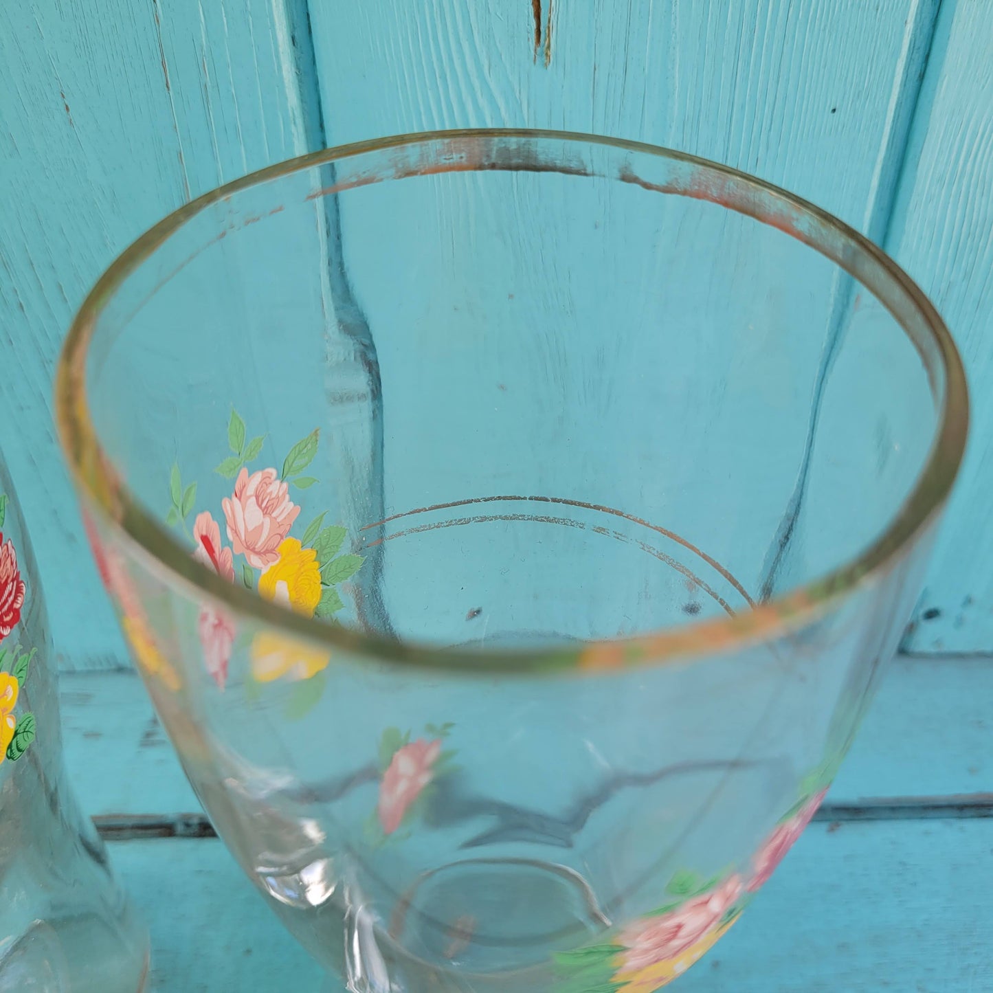 Pair of vintage glass boot vases with floral transfer design