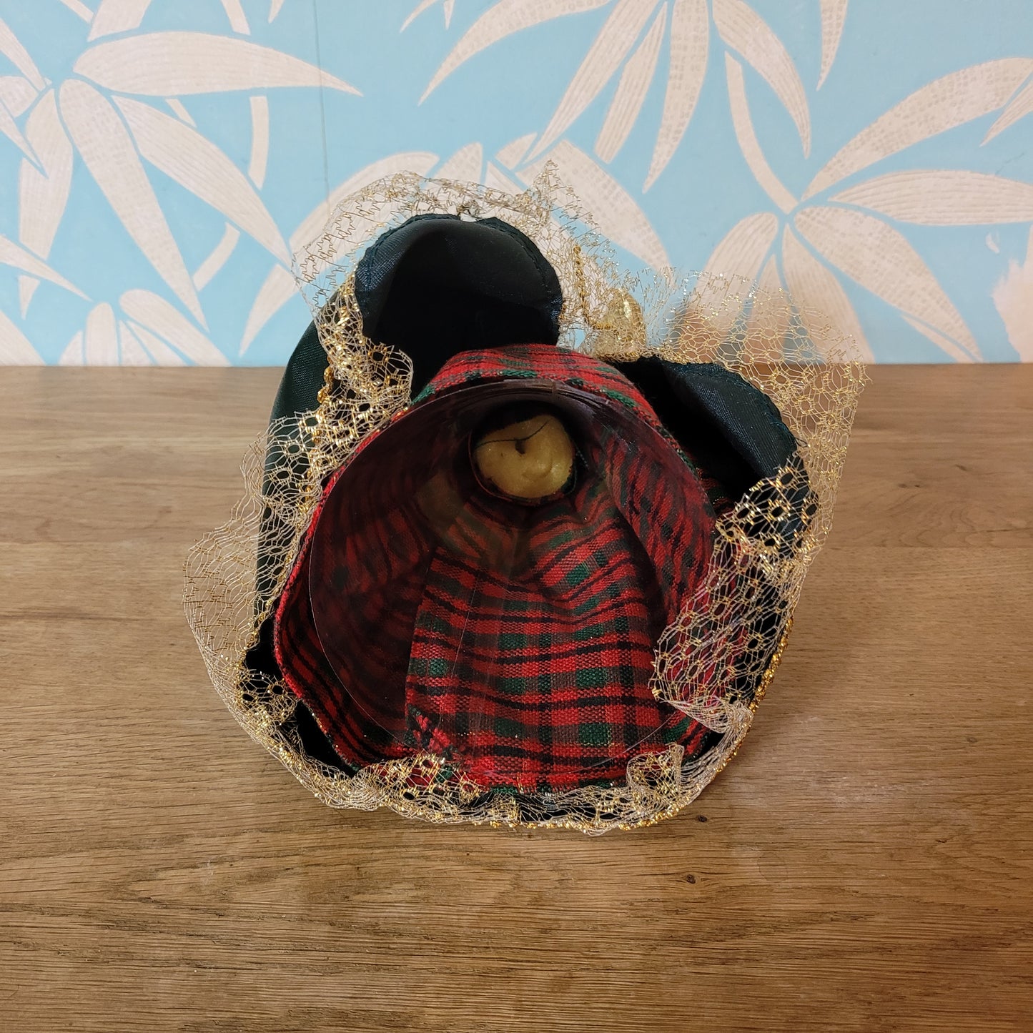 Vintage angel tree topper in plaid-sleeved green dress with porcelain face and hands
