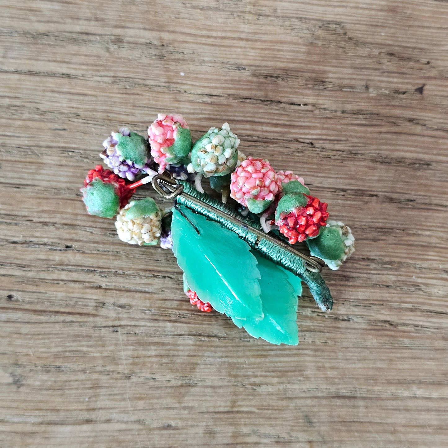 1930s/40s celluloid berry cluster brooch with moulded plastic leaves