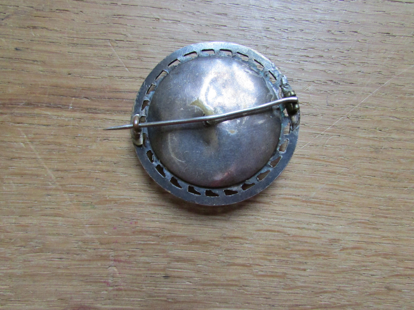 Early 20th century silver-metal diamanté fleur de lys detailed round brooch