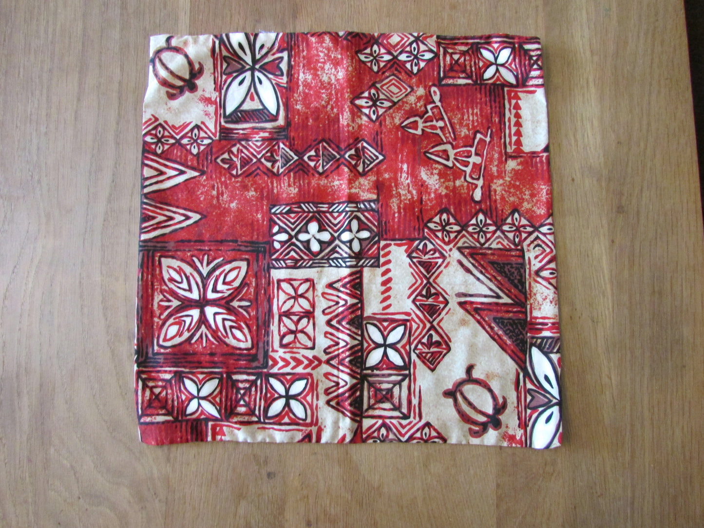 Home-made vintage red Hawaiian-style/tiki pattern cushion cover with same pattern reverse