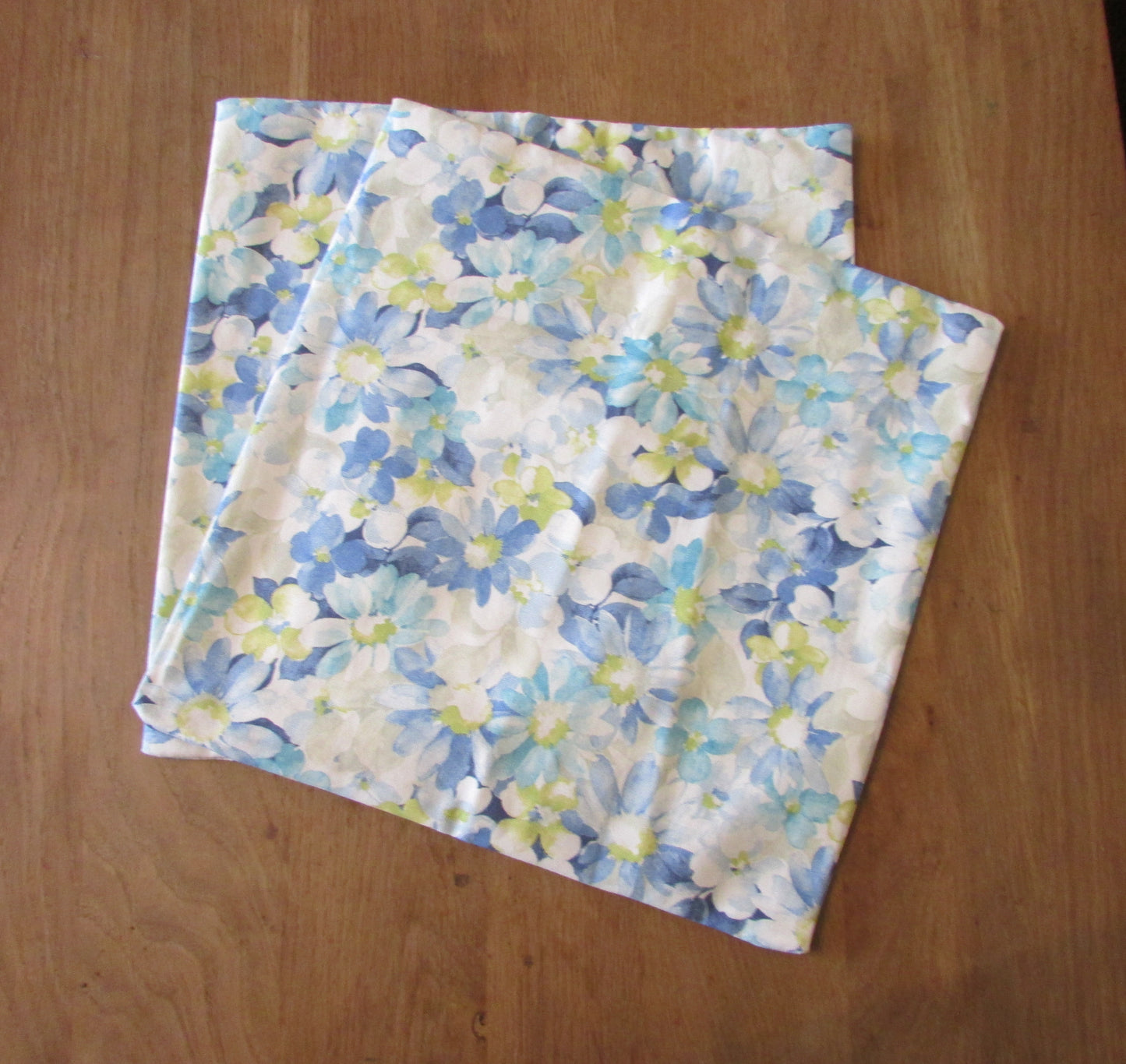 Home-made vintage pastel blues floral pattern cushion cover with same pattern reverse