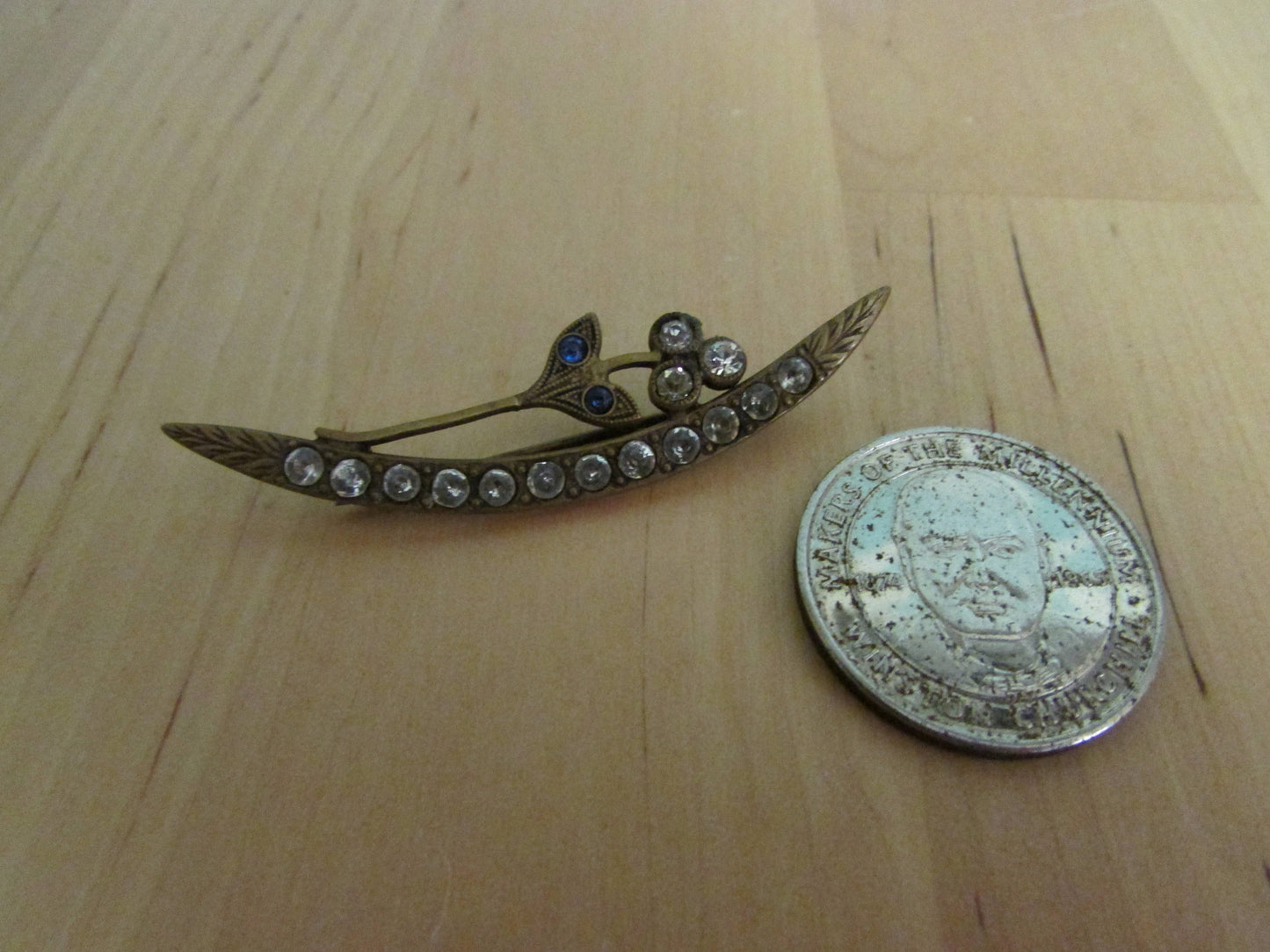 Vintage art nouveau gold-tone crescent-shaped diamanté stick pin with flower detail