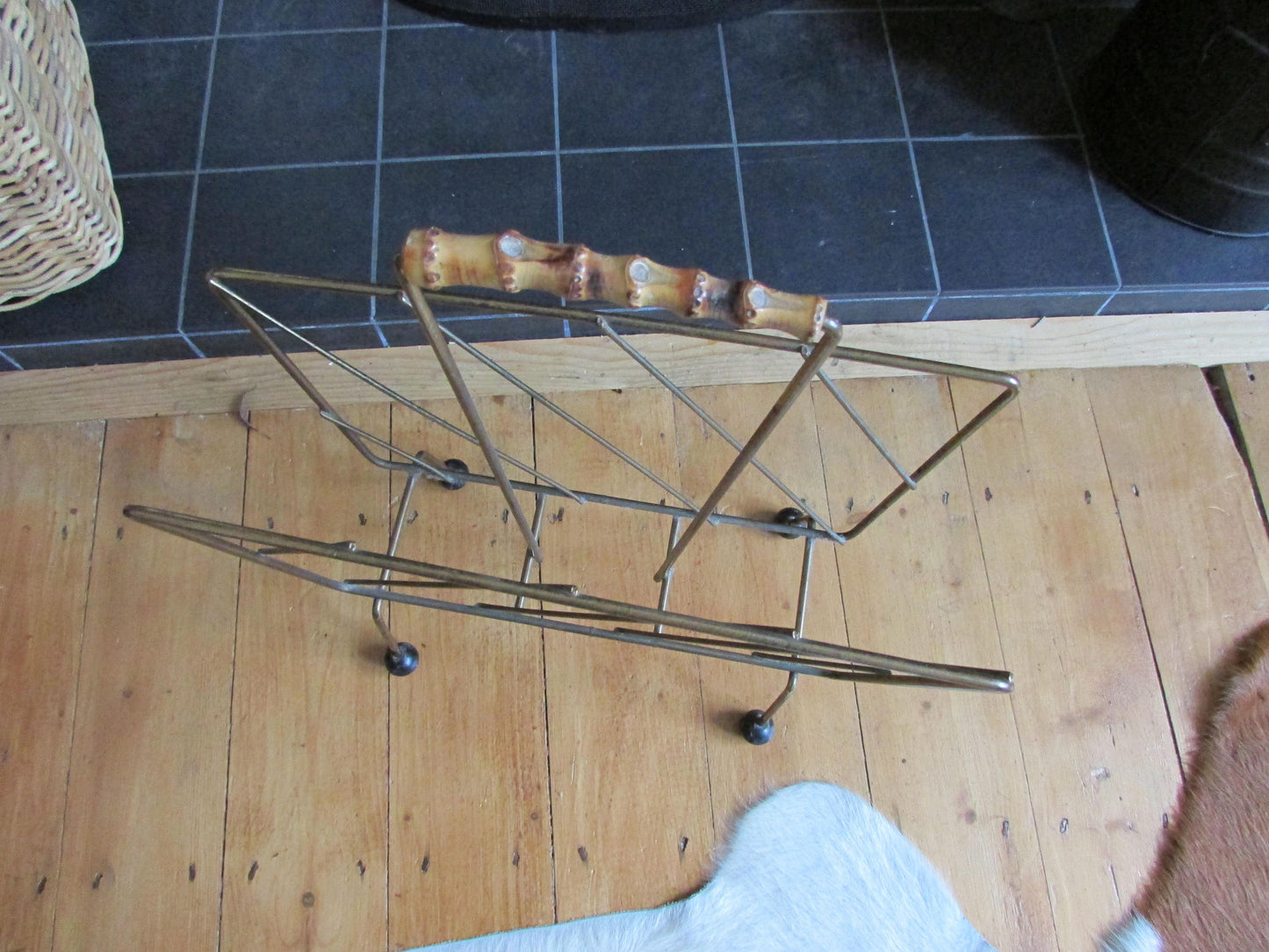 Mid-century metal magazine rack with bamboo handle and ball feet