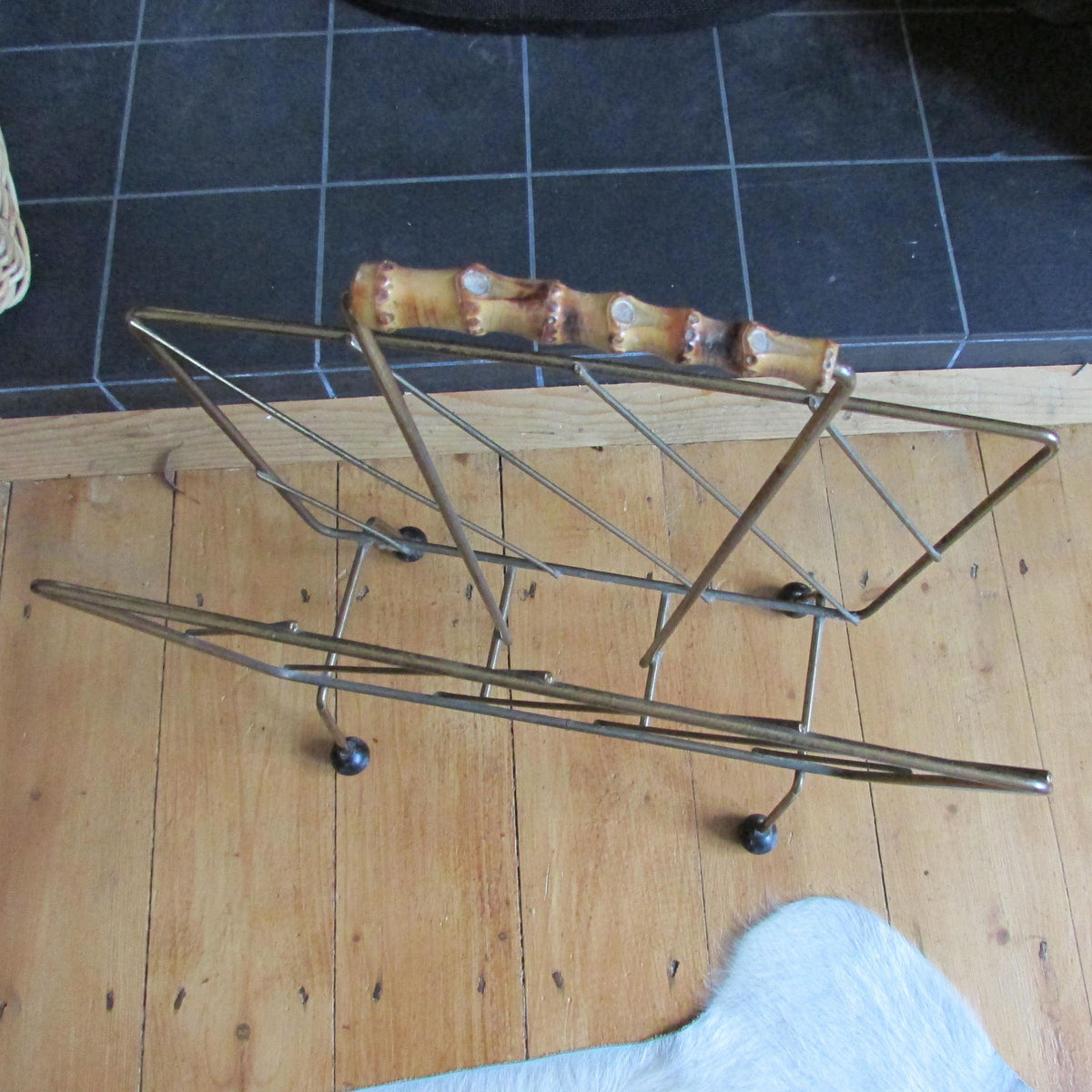 Mid-century metal magazine rack with bamboo handle and ball feet