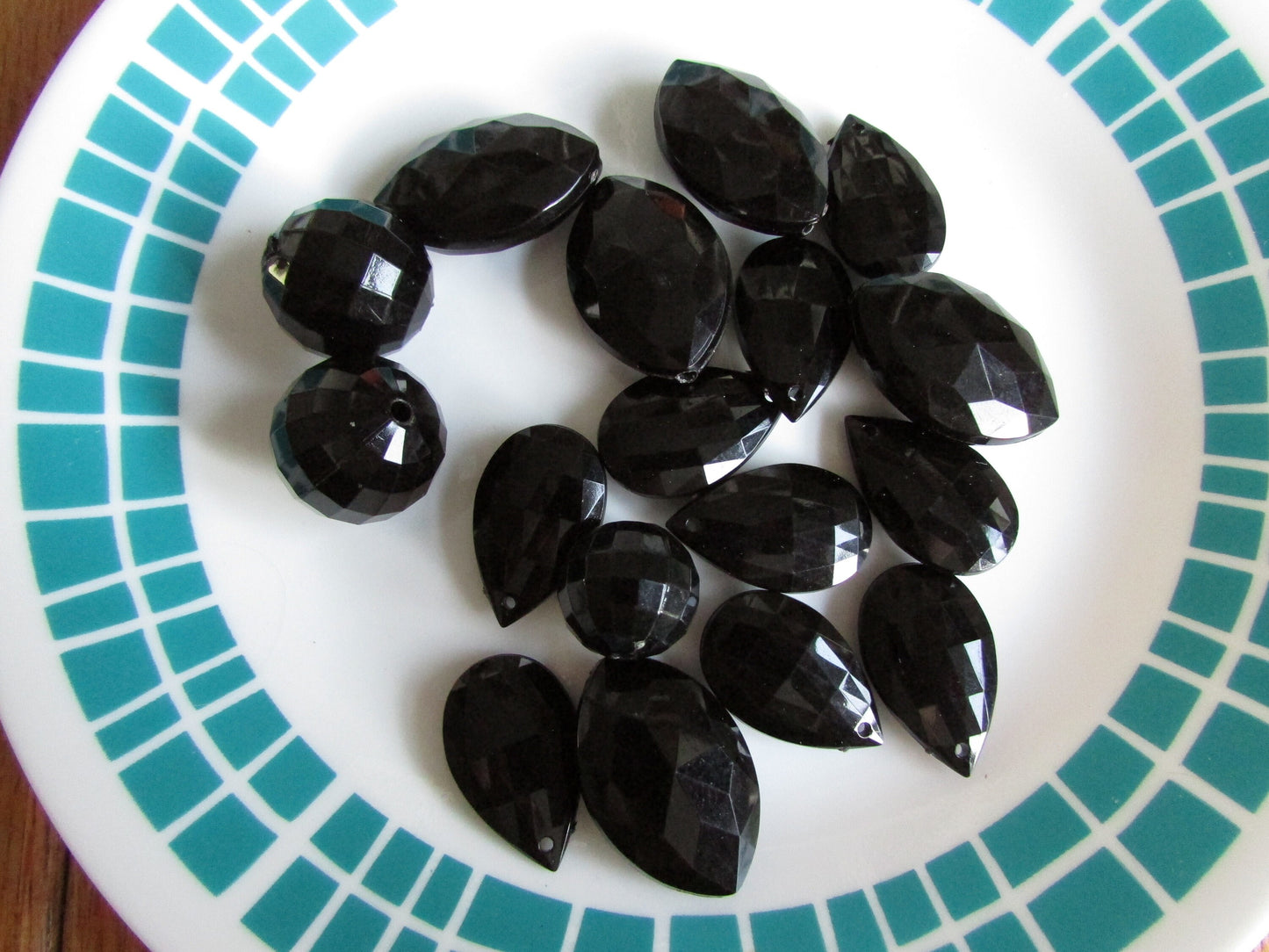 17 vintage black faceted teardrop, elliptical and globe plastic beads