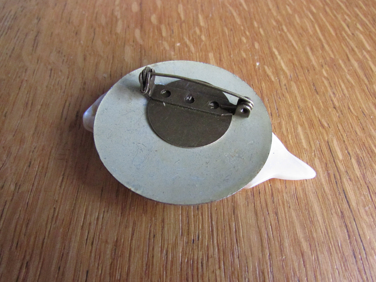 Home-made brooch using vintage Mother of Pearl fish and metal patterned disc earring back