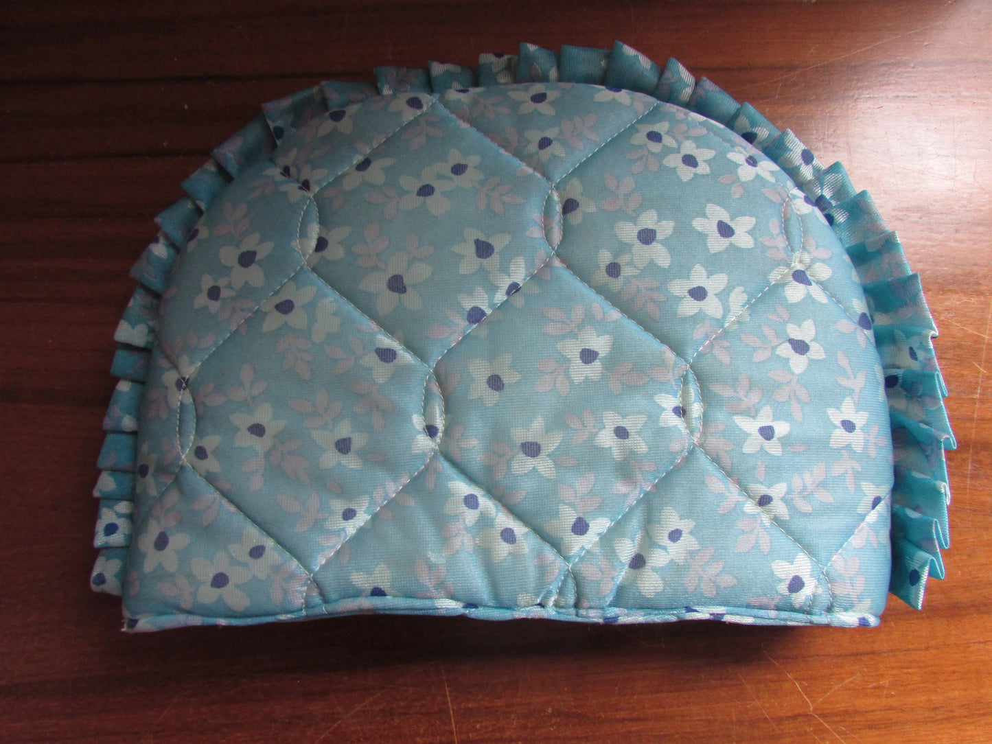 Vintage quilted blue floral tea cosy with ruffle edging