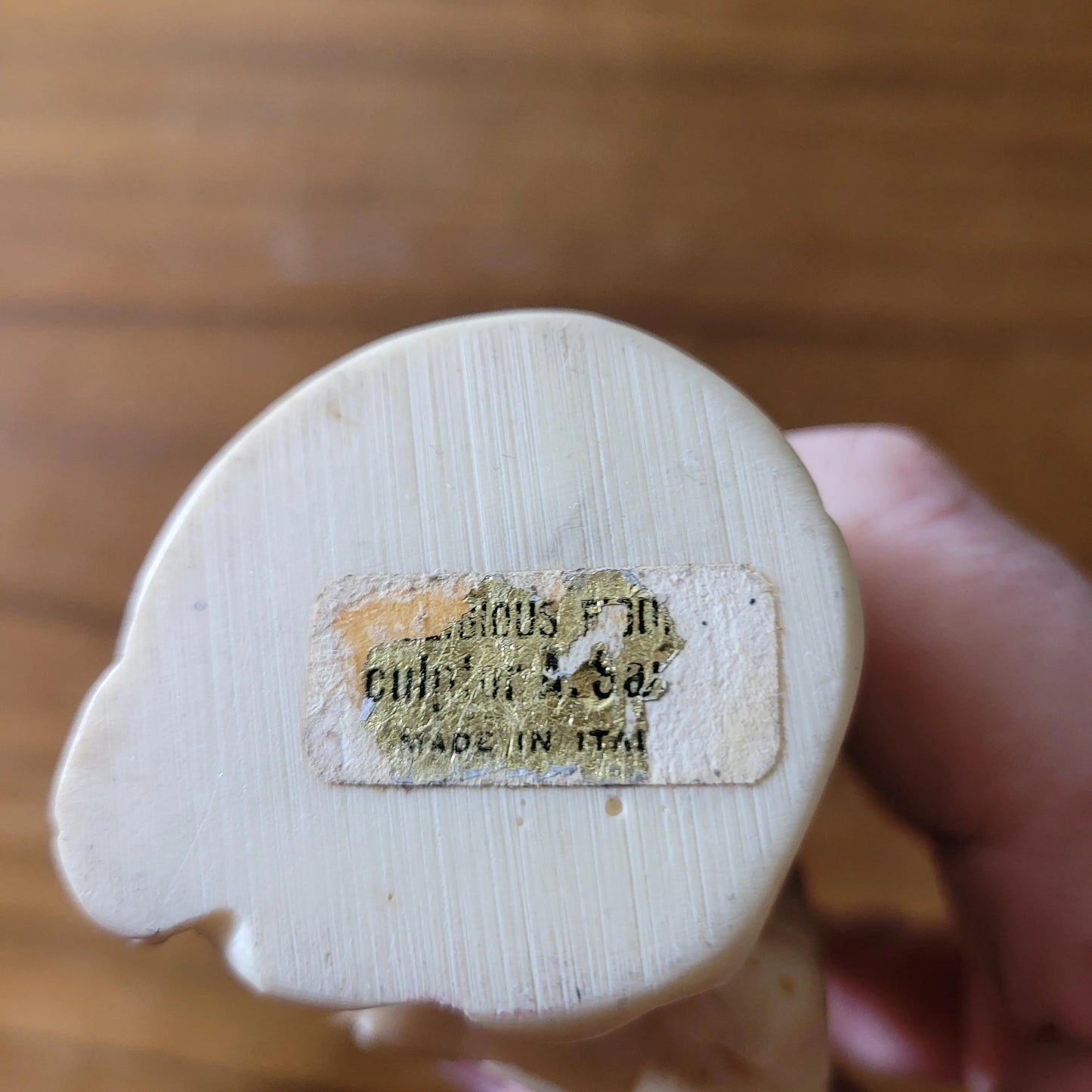 Pair of 1960s/70s ivory-coloured resin singing monk figurines, signed A. Santini