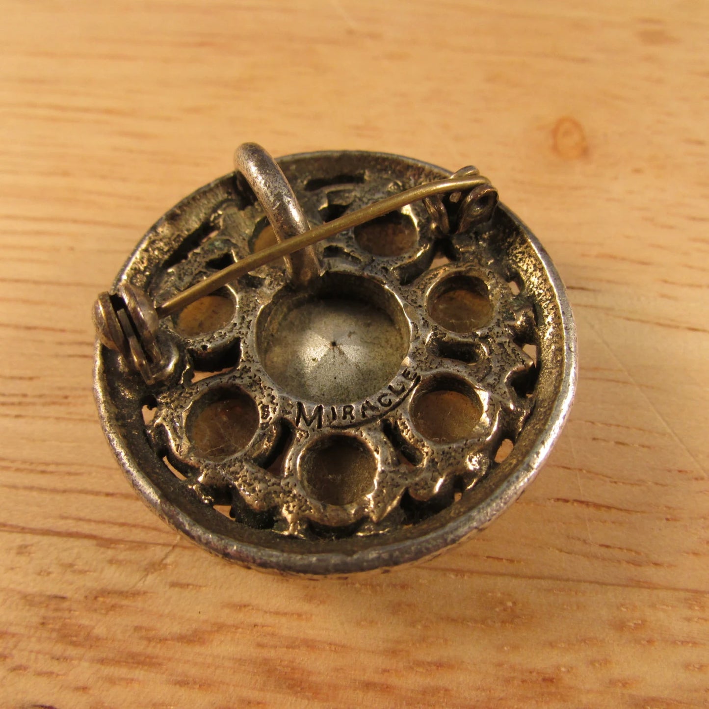 1970s round Celtic-style pendant/brooch, polished green stones with citrine centre, stamped MIRACLE