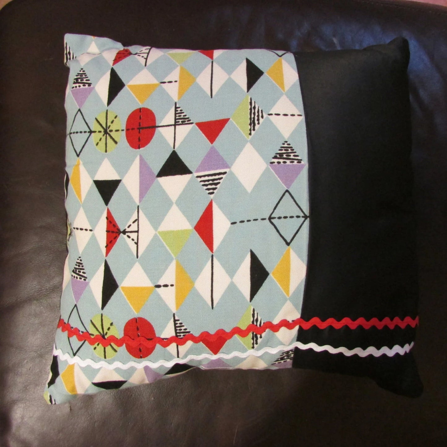Home-made mid-century Marian Mahler atomic fabric cushion with red, & white ric-rac, and contrast black reverse