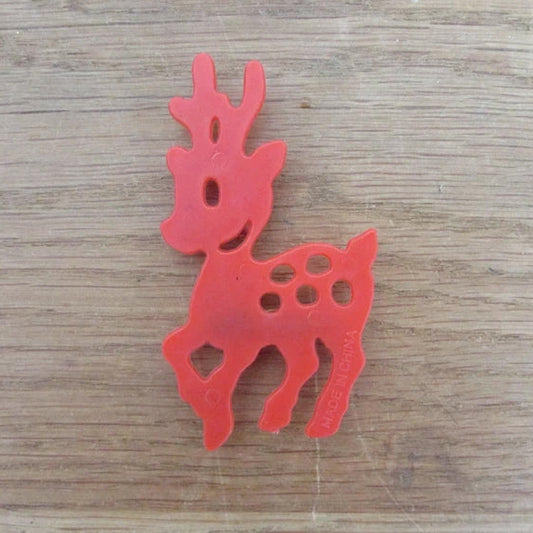 Kitsch home-made brooch using vintage red plastic deer cake topper