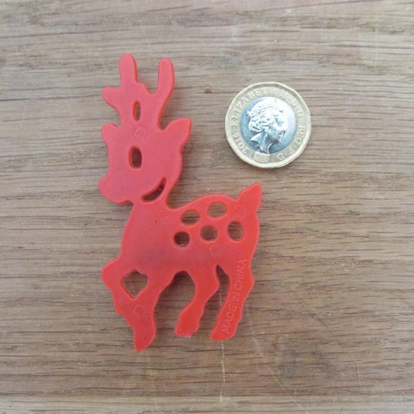 Kitsch home-made brooch using vintage red plastic deer cake topper