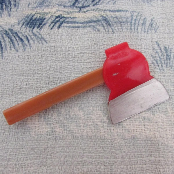 Kitsch home-made brooch using vintage plastic hatchet/axe cake topper