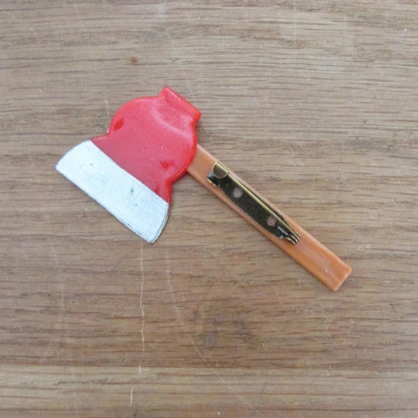 Kitsch home-made brooch using vintage plastic hatchet/axe cake topper