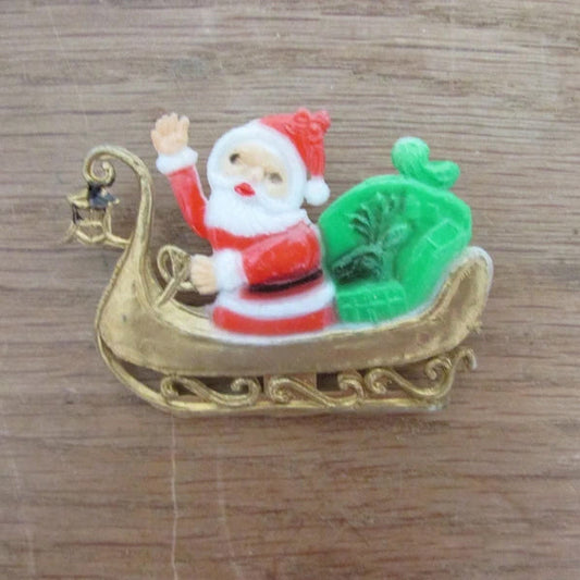 Kitsch home-made brooch using vintage plastic Santa in sleigh cake topper