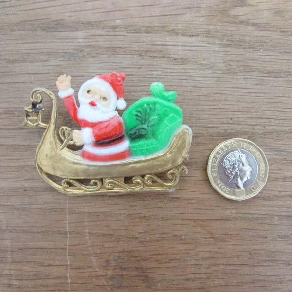 Kitsch home-made brooch using vintage plastic Santa in sleigh cake topper