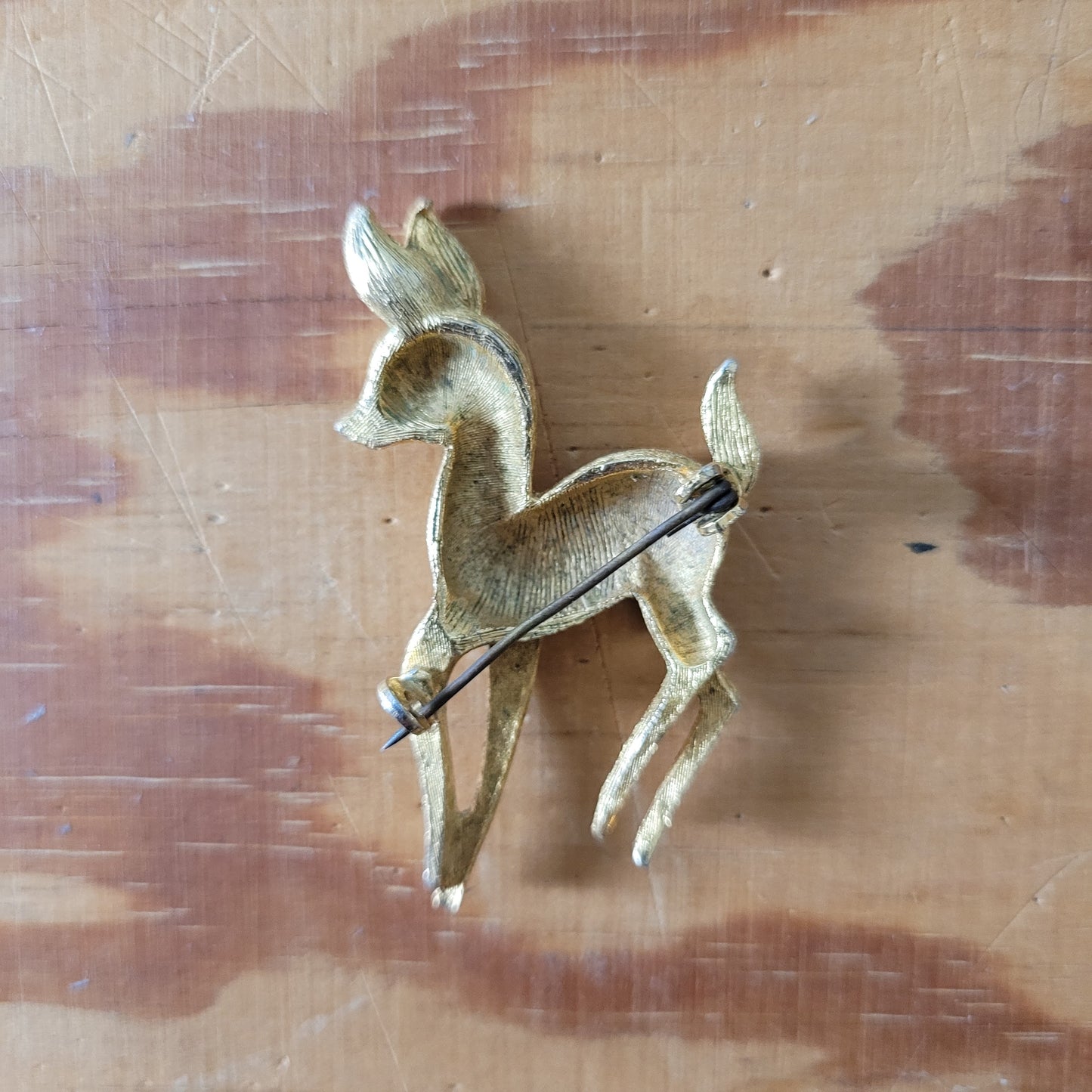 1950s gold-tone fawn brooch with red rhinestone eye