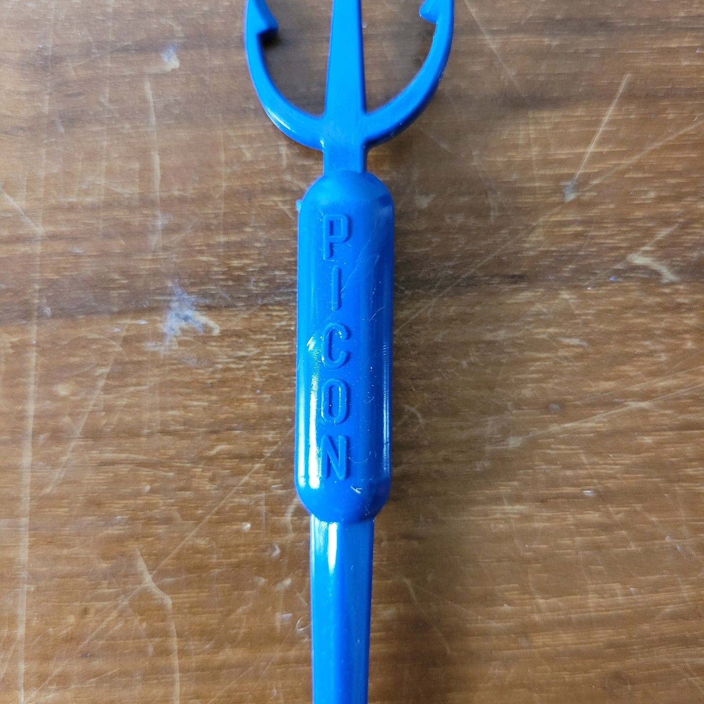Vintage plastic trident cocktail stirrer, stamped PICON