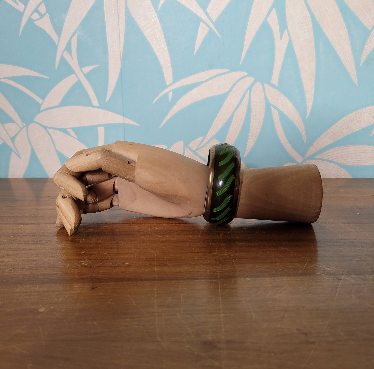 circa. 1980s postmodern black lacquered bangle with green brushstroke motif and brass trim