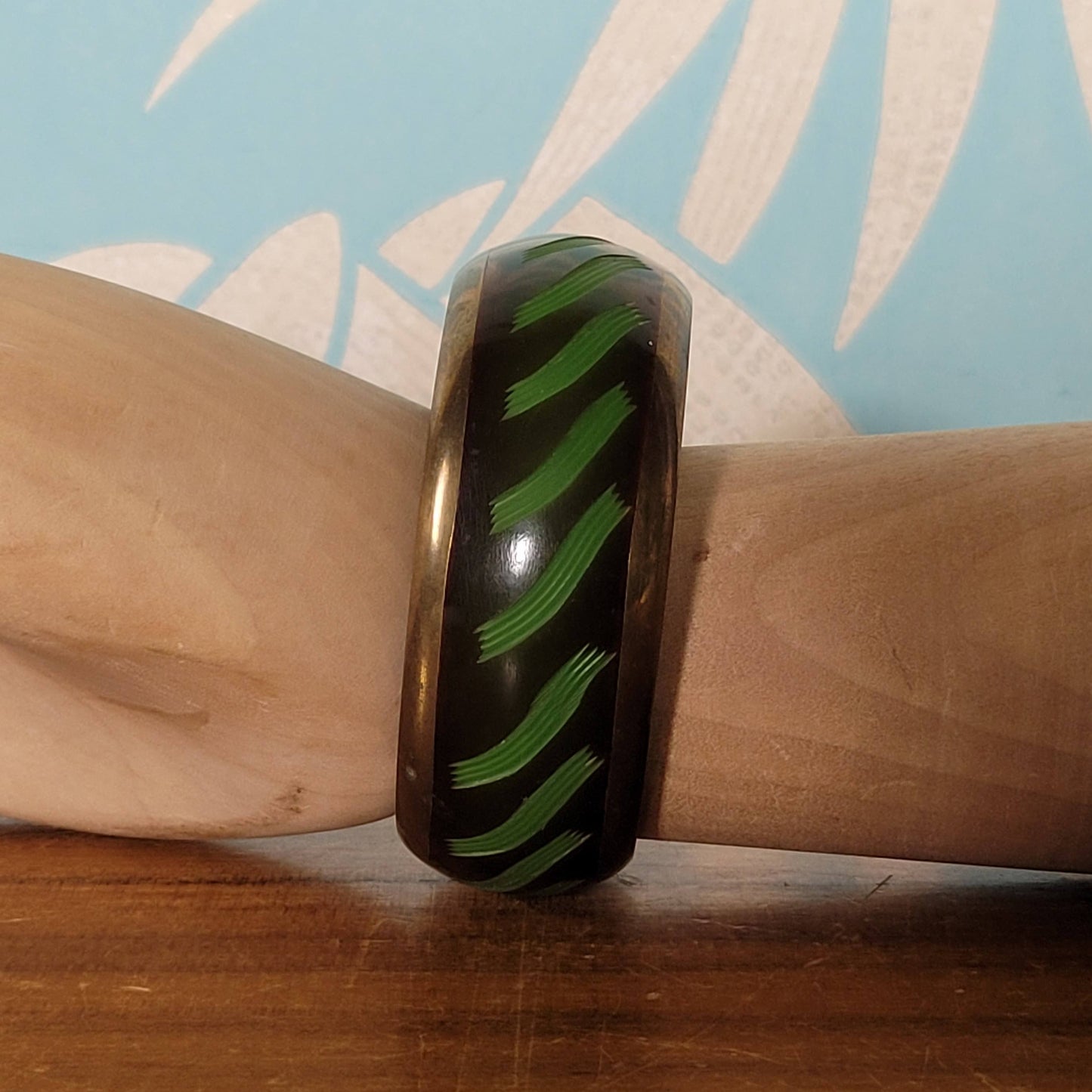 circa. 1980s postmodern black lacquered bangle with green brushstroke motif and brass trim