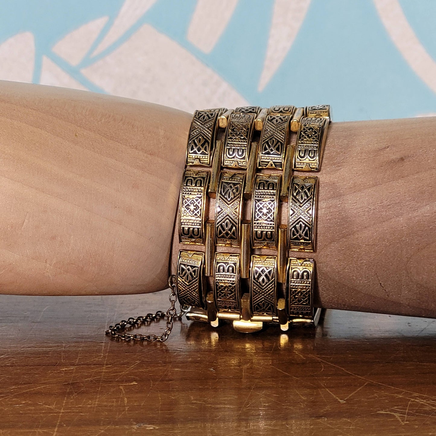 Vintage Damascene gold-tone four row tank bracelet with safety chain.