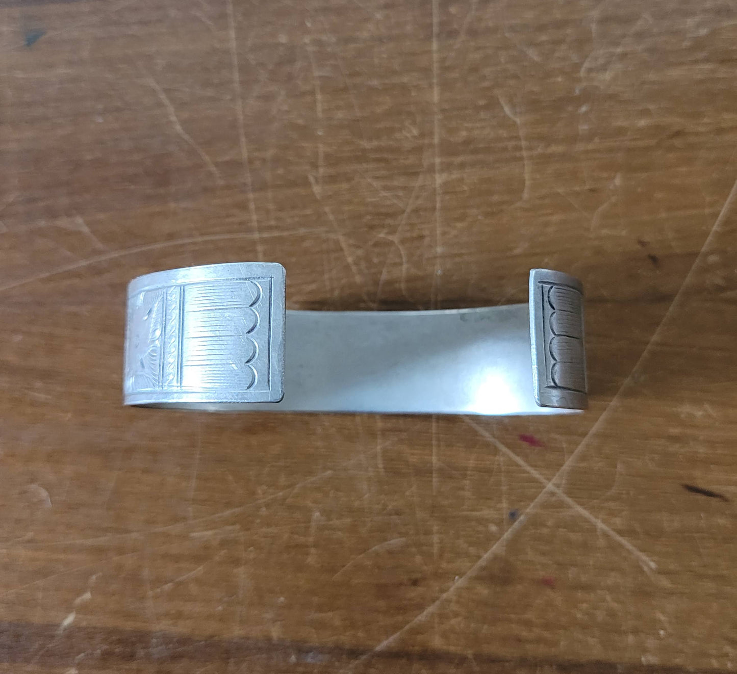 Mid-century engraved silver tone cuff bracelet with bird and foliate design