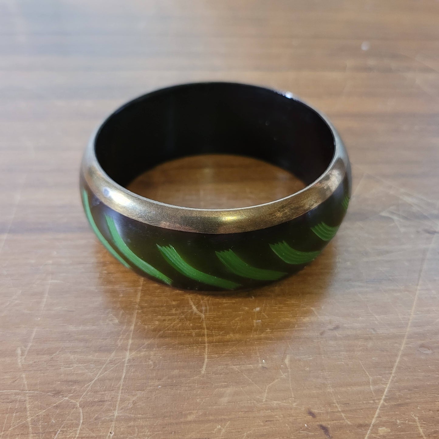 circa. 1980s postmodern black lacquered bangle with green brushstroke motif and brass trim