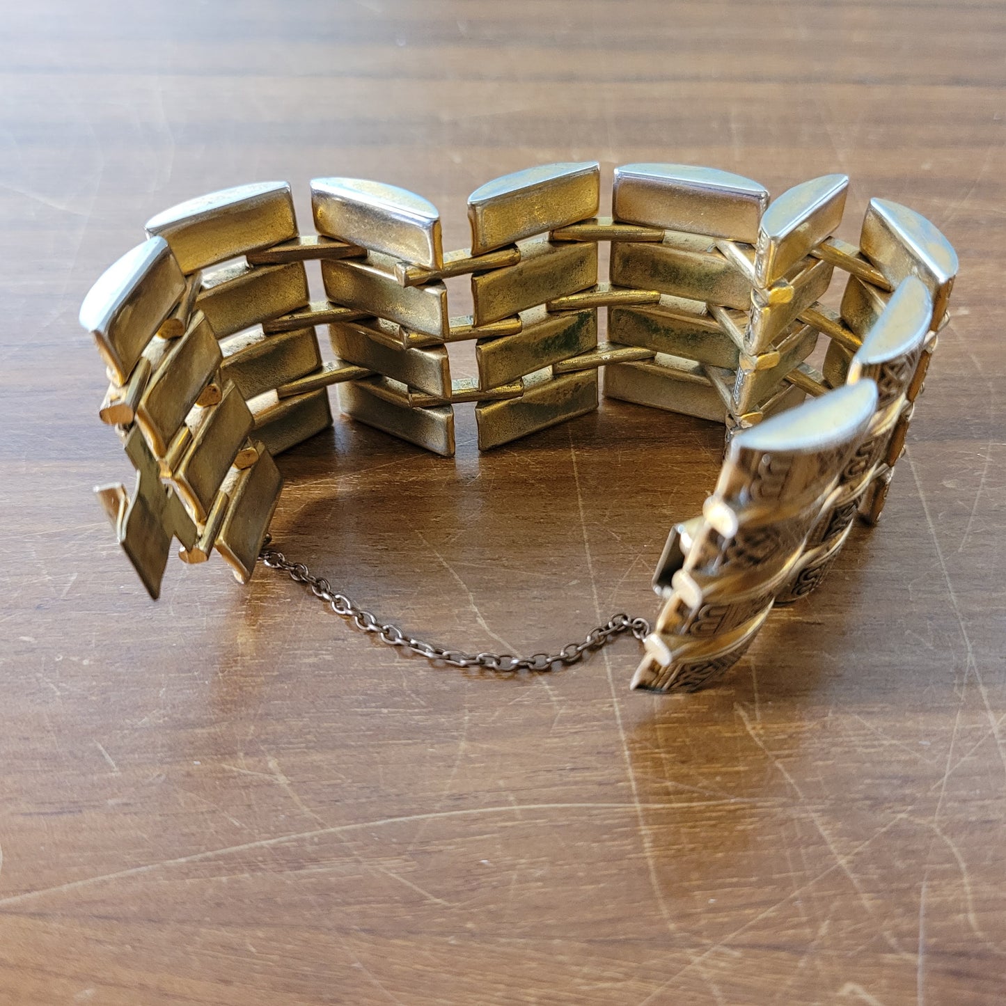 Vintage Damascene gold-tone four row tank bracelet with safety chain.