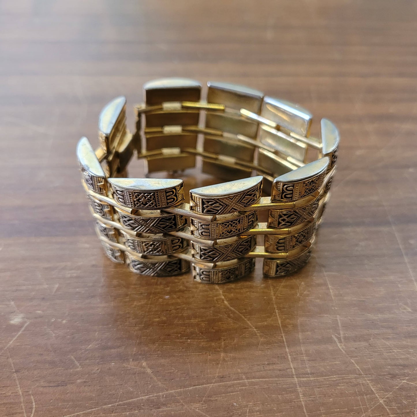 Vintage Damascene gold-tone four row tank bracelet with safety chain.