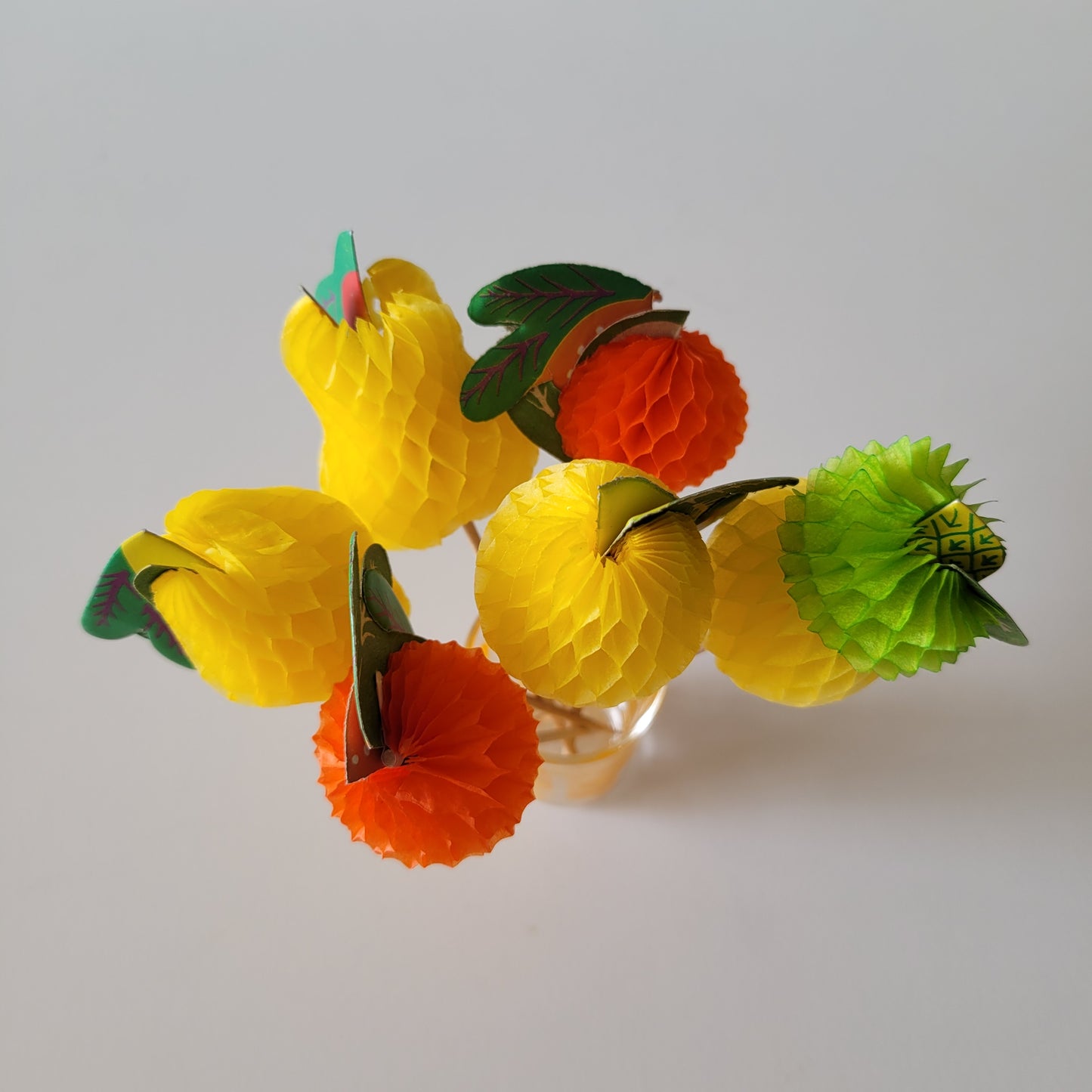 Assortment of retro paper honeycomb fruit cocktail sticks
