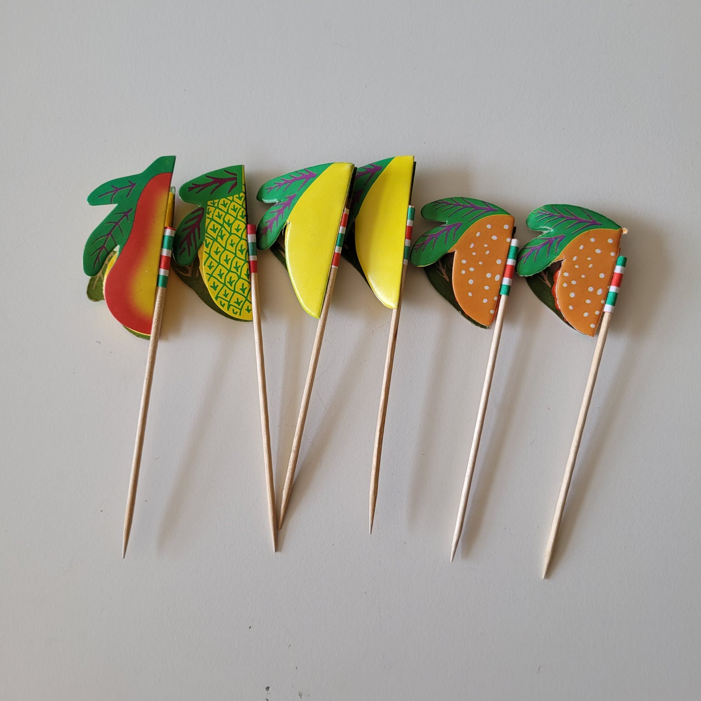Assortment of retro paper honeycomb fruit cocktail sticks