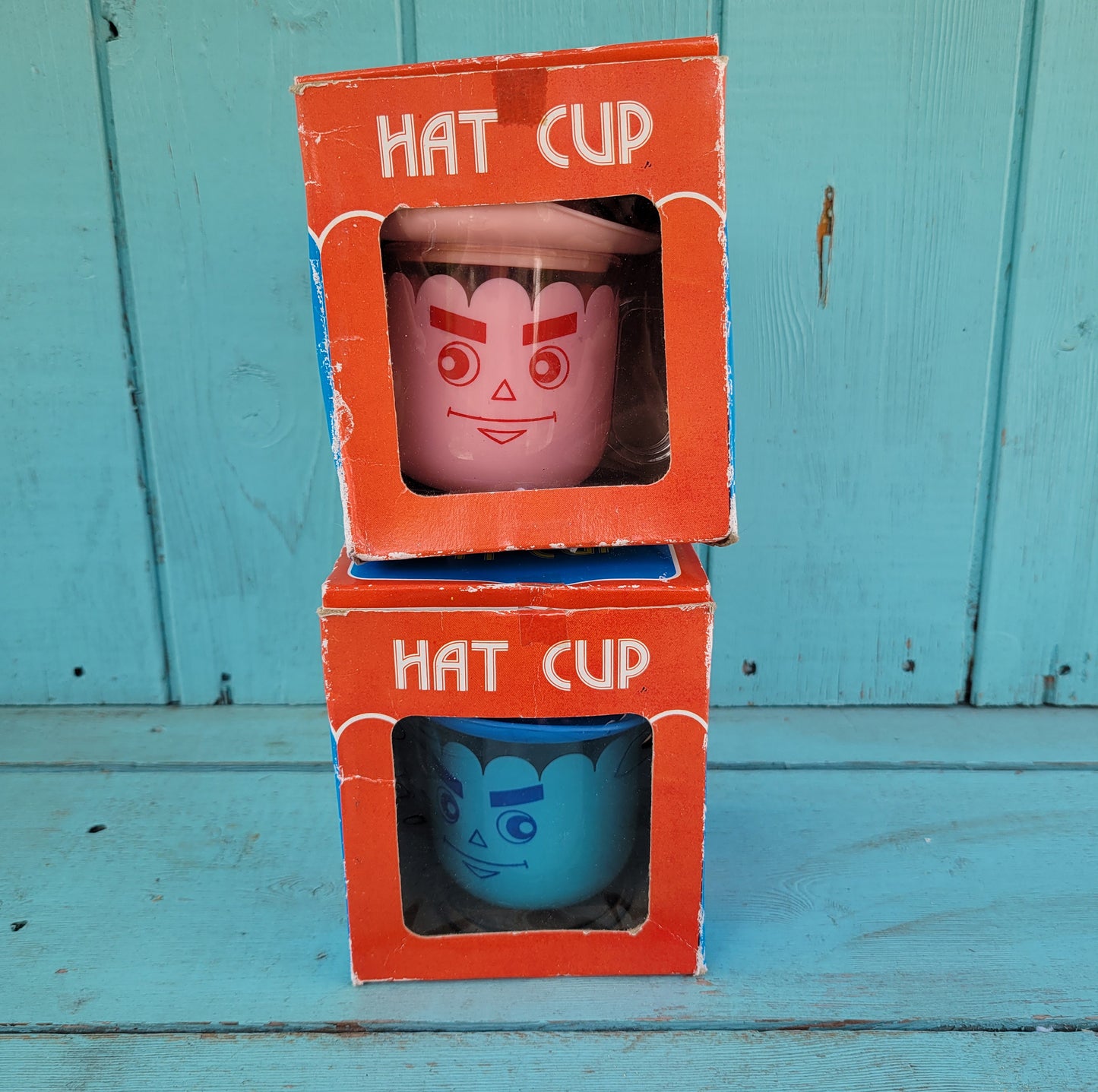 Two vintage plastic 'Hat' cups, with original packaging, in pink & blue