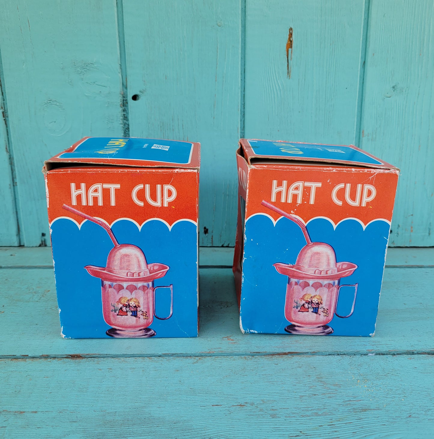 Two vintage plastic 'Hat' cups, with original packaging, in pink & blue