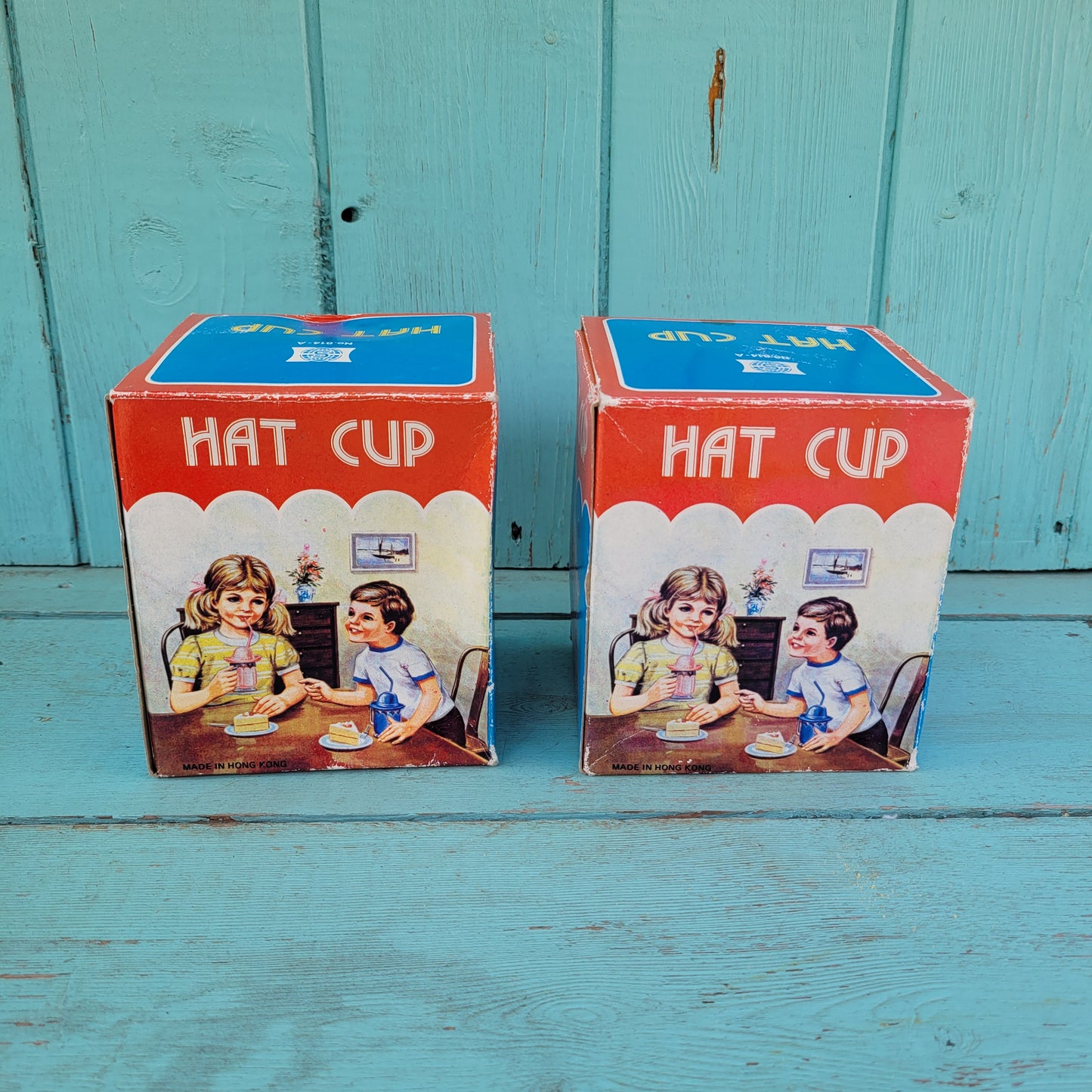 Two vintage plastic 'Hat' cups, with original packaging, in pink & blue