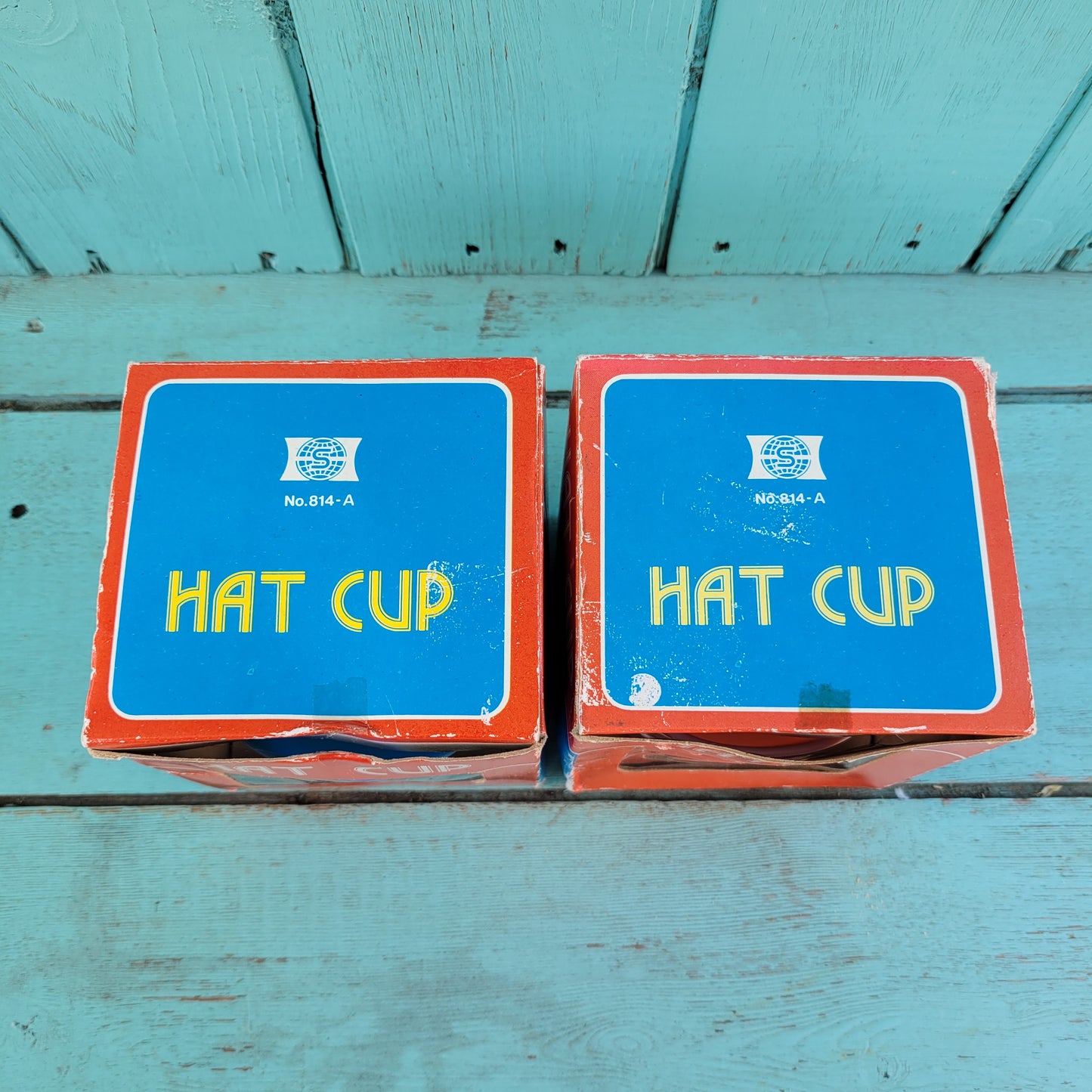 Two vintage plastic 'Hat' cups, with original packaging, in pink & blue