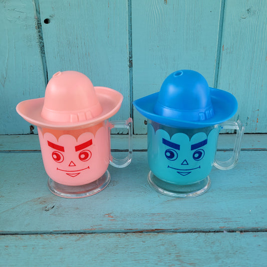 Two vintage plastic 'Hat' cups, with original packaging, in pink & blue