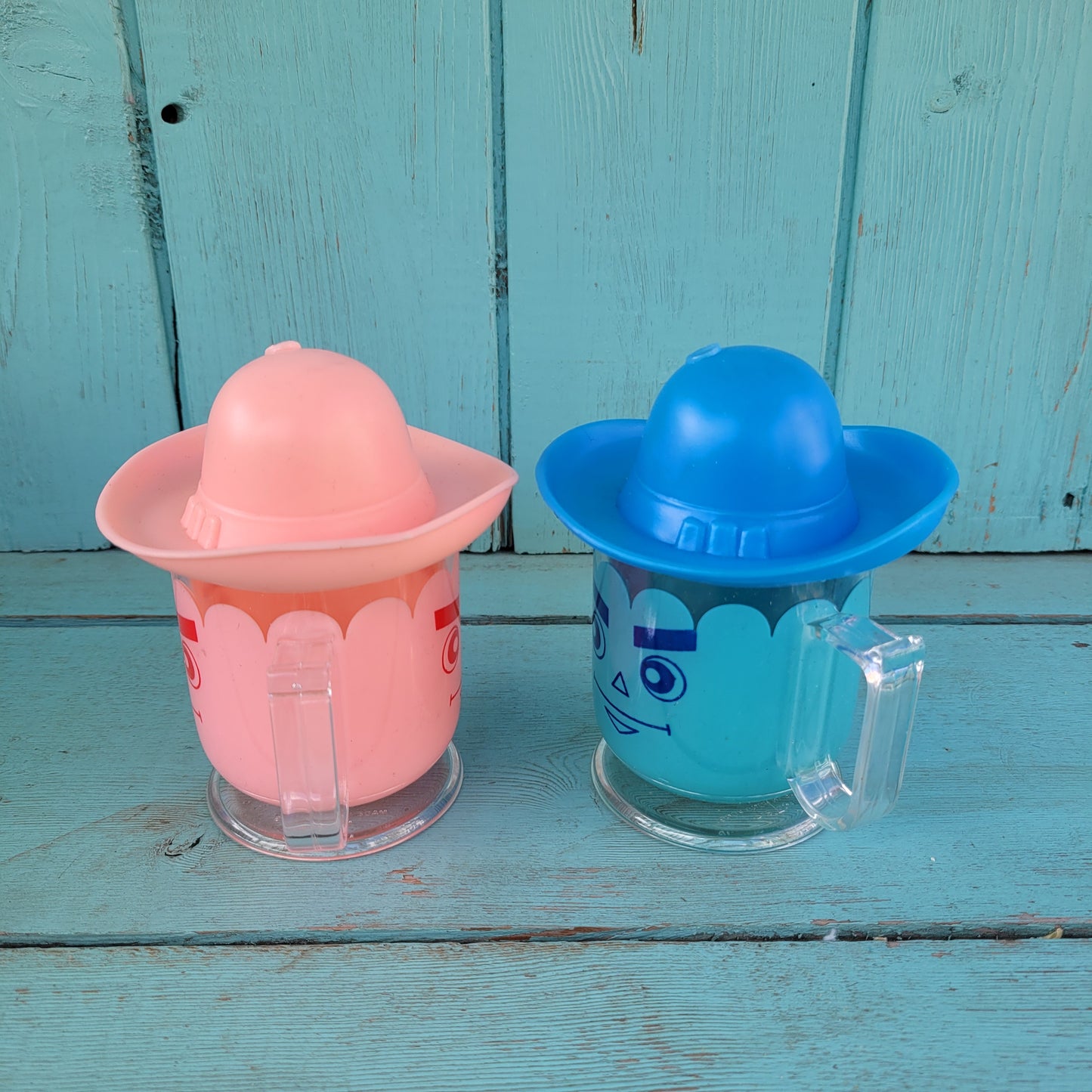 Two vintage plastic 'Hat' cups, with original packaging, in pink & blue