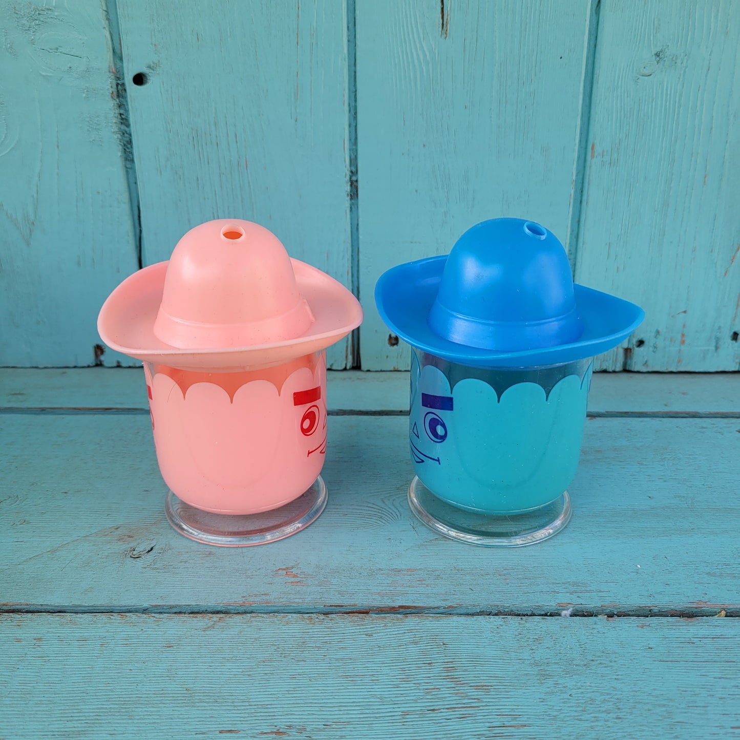 Two vintage plastic 'Hat' cups, with original packaging, in pink & blue