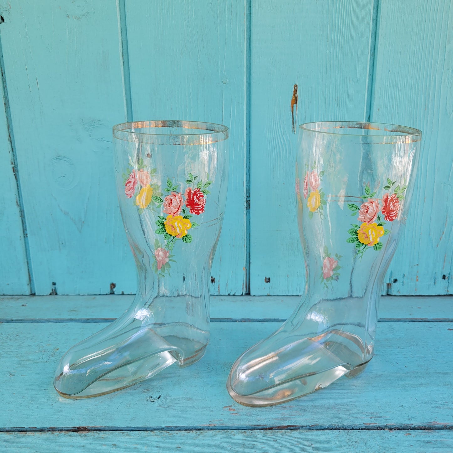 Pair of vintage glass boot vases with floral transfer design