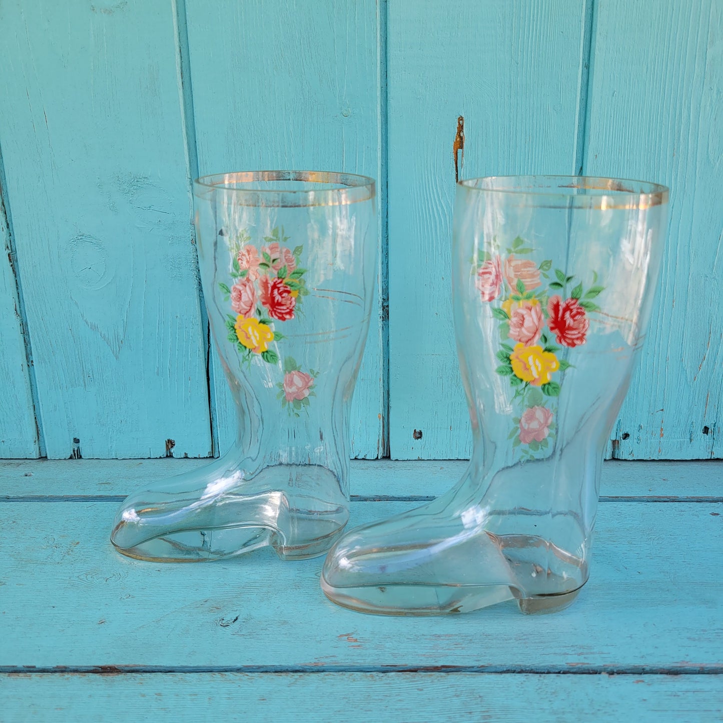 Pair of vintage glass boot vases with floral transfer design