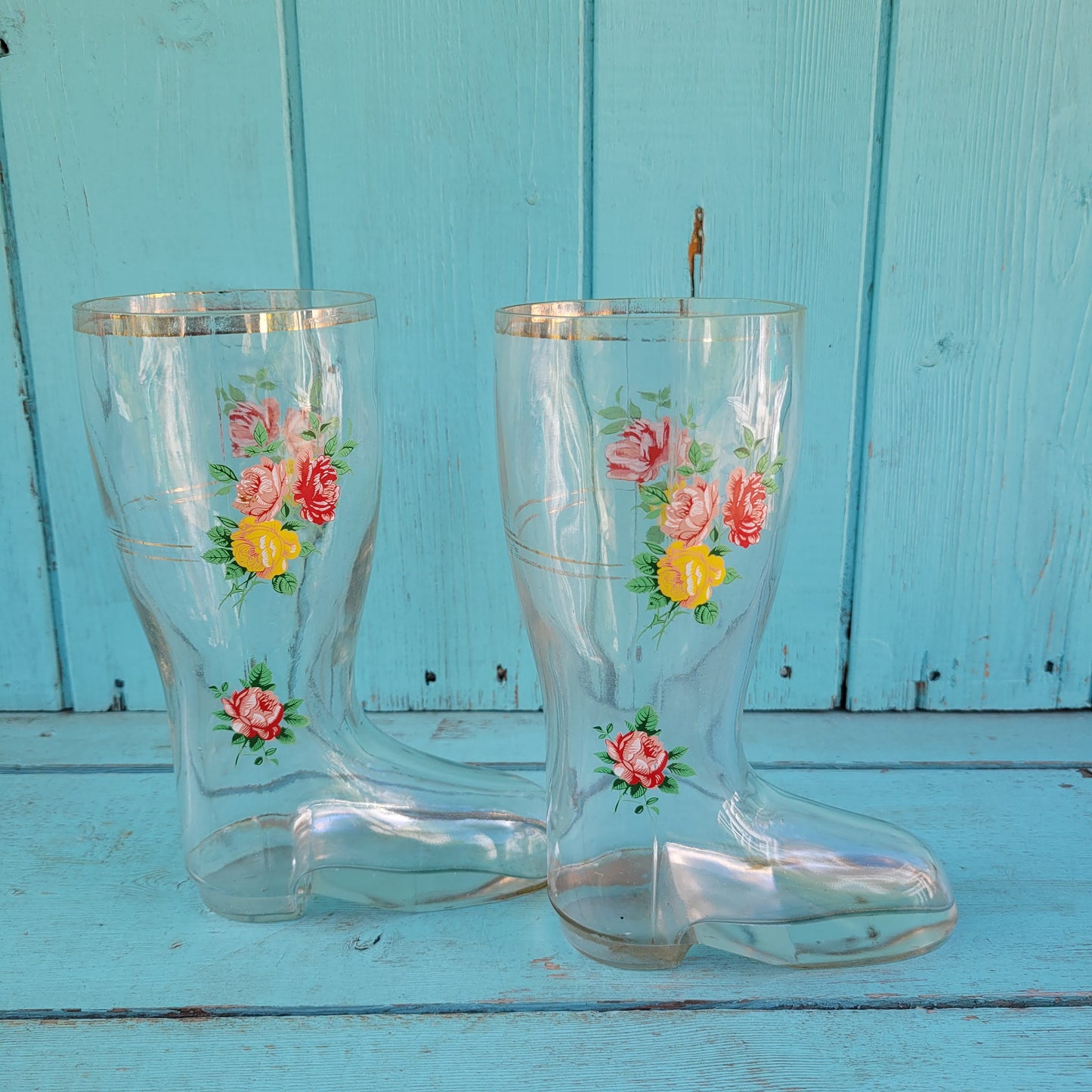 Pair of vintage glass boot vases with floral transfer design