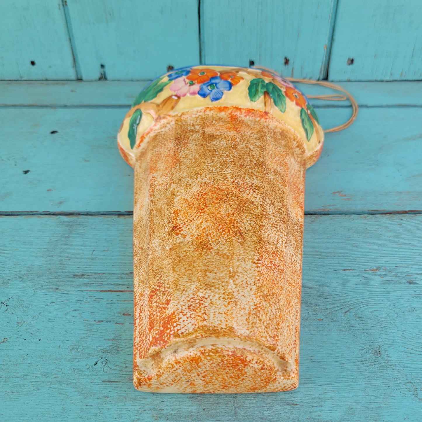 Art Deco Wadeheath Ware orange/rust ceramic wall planter with handpainted floral rim, stamped 224