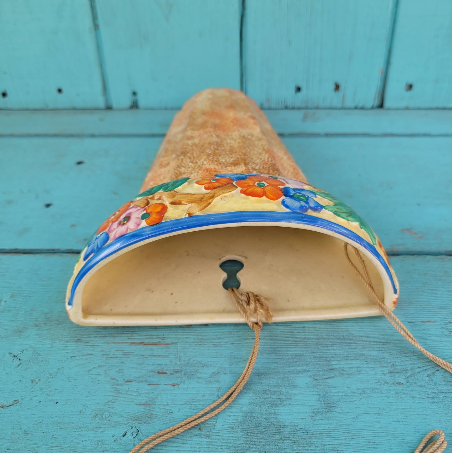 Art Deco Wadeheath Ware orange/rust ceramic wall planter with handpainted floral rim, stamped 224