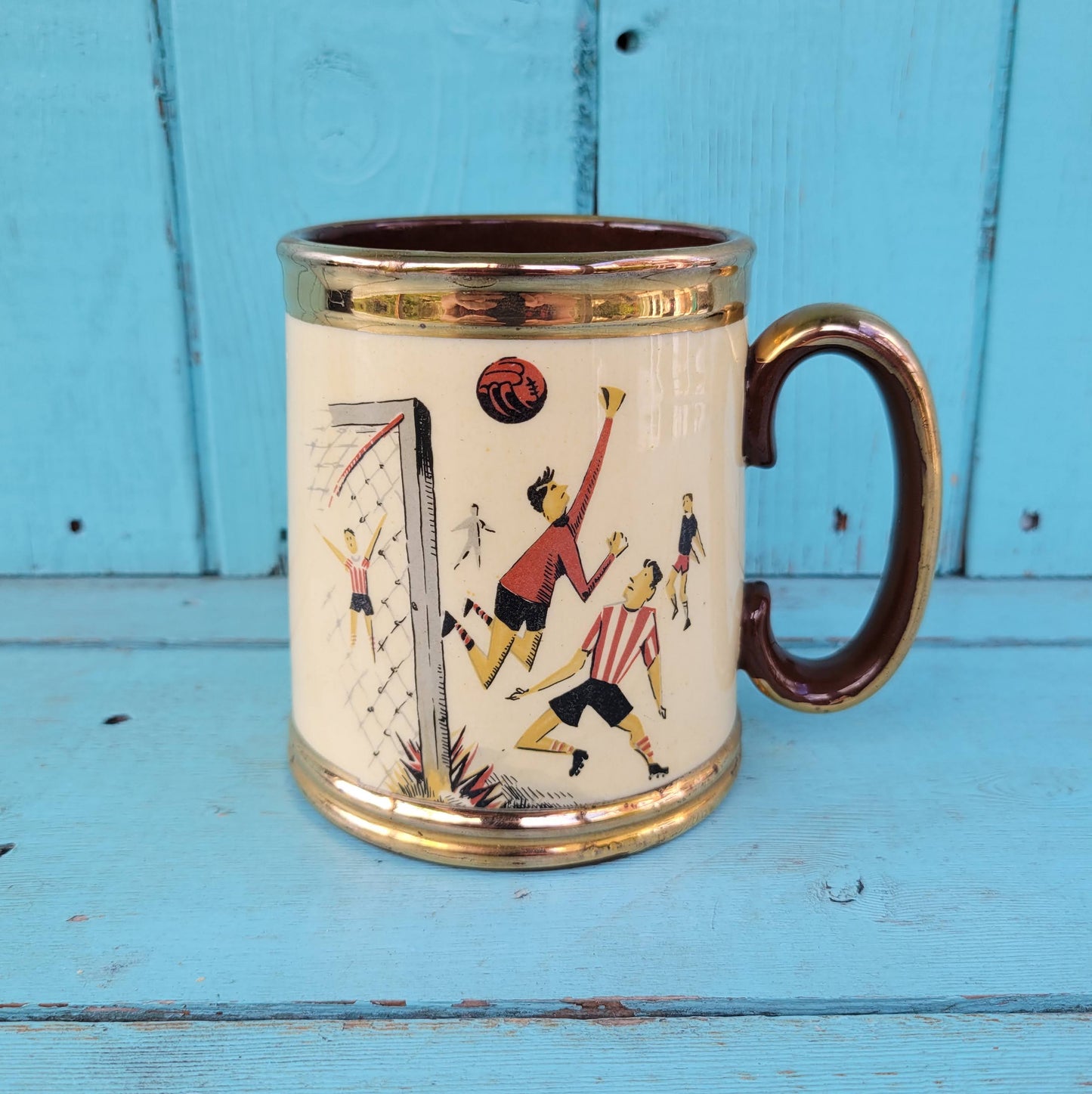 Collectable 1950s Gibsons china tankard with copper gilt edging and football players motif