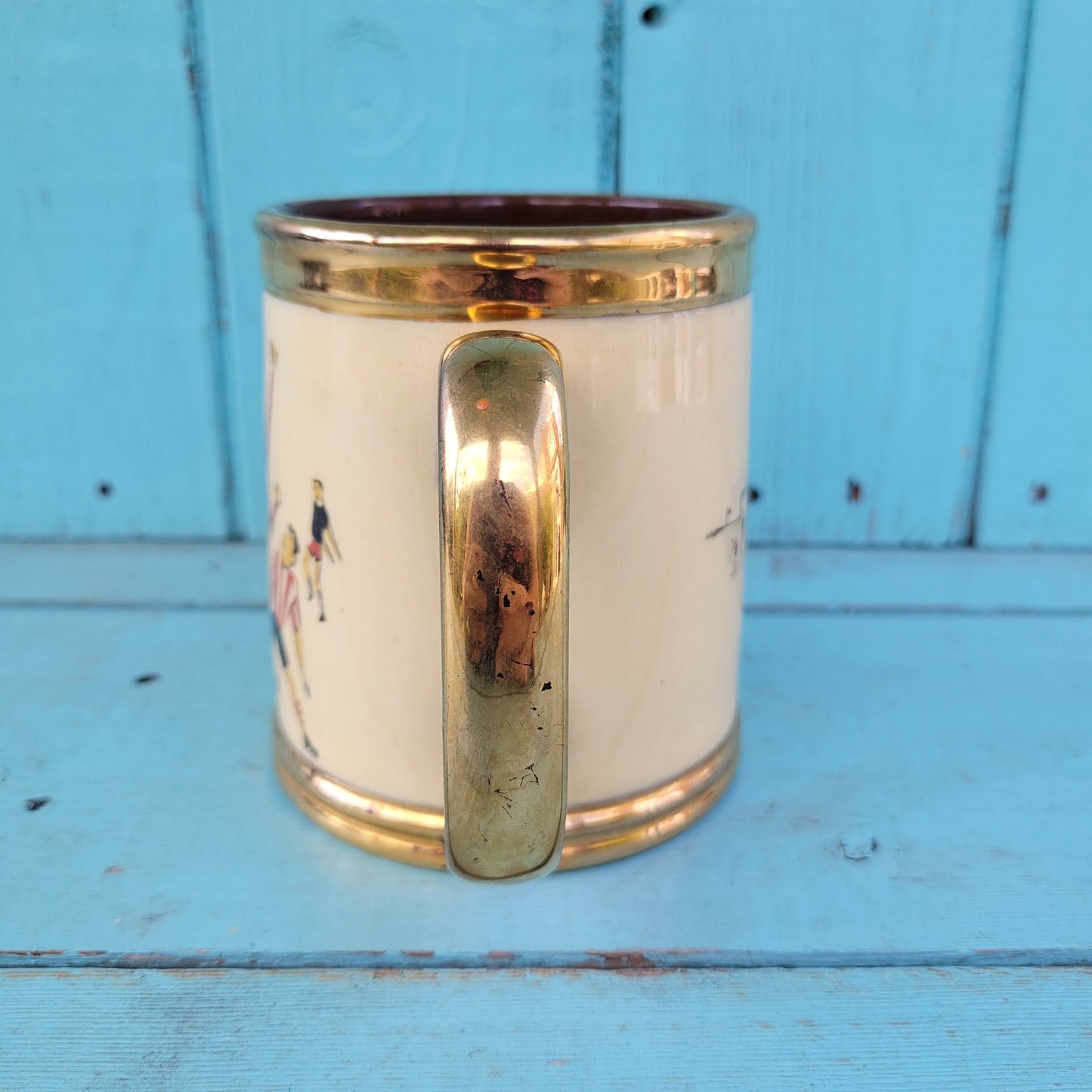 Collectable 1950s Gibsons china tankard with copper gilt edging and football players motif